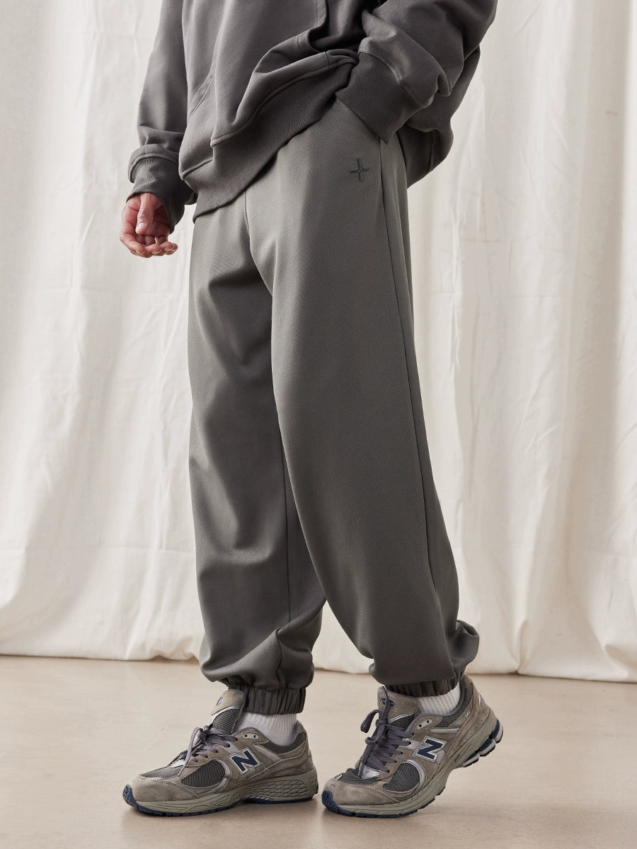 Calças masculinas americanas de cor sólida minimalistas bordadas soltas com faixa no tornozelo